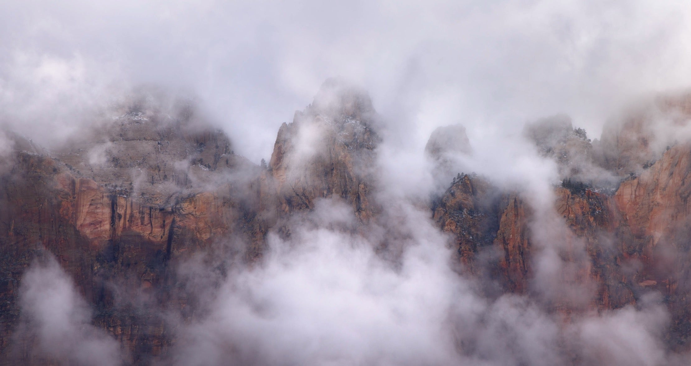 Landscape photo edited with Rethink Landscape presets, showing fog and clouds around dramatic peaks